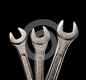 Three metallic wrenches