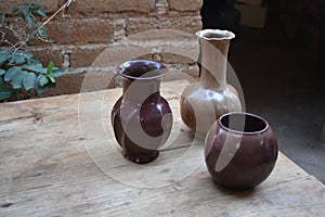 Three mexican clay vases on a rustic scene