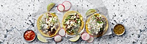 Three mexican street tacos with barbacoa and queso fresco cheese photo