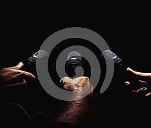 Three Microphones in Hands