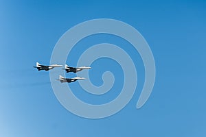 Three military F16 fighter jets flying through the air during military forces parade. Airplanes In Formation.