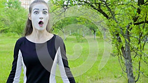 Three mimes imitate to turn camera