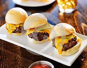 Three mini burger sliders in a row photo