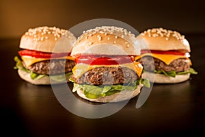 Three mini burgers in a dark ambient