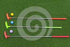 Three Mini Golf Putters With Balls