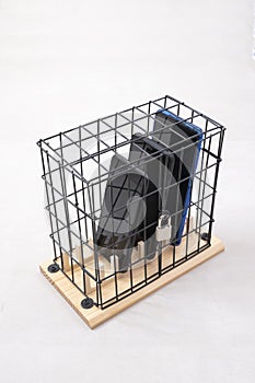 Three mobile phones locked in a cage with a padlock, concept of social isolation or phone abuse and social networks, white