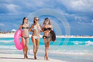 Three models on a tropical beach with a circle