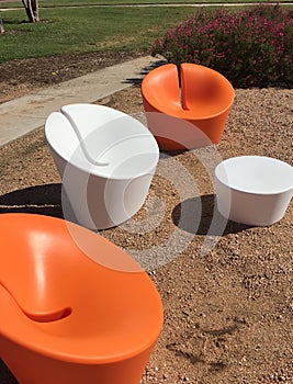Three modern design chairs and table in a park