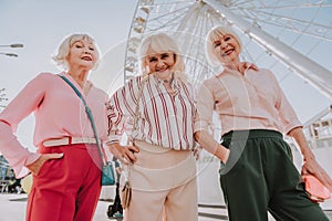 Three modern grannies are posing for photo