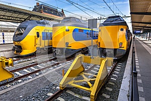 Three modern trains waiting at station