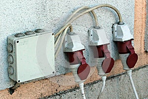 Three moisture protected electrical outlets on an outer wall