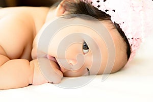 Three month old asian baby is prone