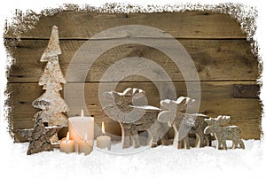 Three mooses wearing santa hats on grey wooden background