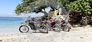 THREE MOTORCYCLES ON THE BEACH