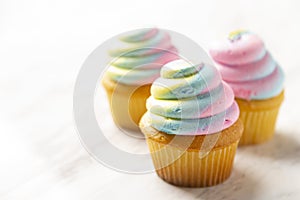 Three Multi Colored Cupcakes
