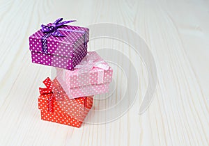 Three multi-colored gift box