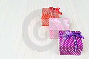 Three multi-colored gift box