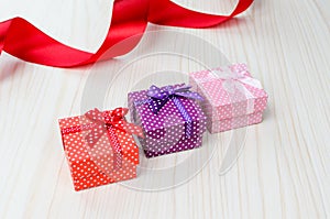 Three multi-colored gift box