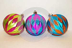 Three multicolored christmas ornaments isolated on a white background