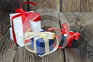 Three multicolored gift boxes with red and yellow ribbons