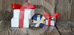 Three multicolored gift boxes with red and yellow ribbons