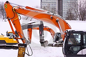 Dance of excavators in the snow photo