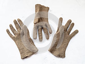 Three new handmade felted green gloves on gray