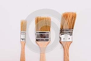 Three new painter brushes of various sizes isolated on white background