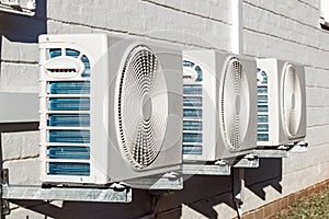 Three Newly Installed Airconditioning Units Mounted on Wall