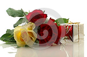 Three nice roses with a gift box