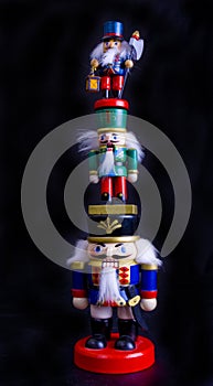 Three nutcracker toys standing on each other