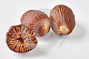 three nutmegs on a white background with copy