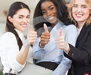 Three smiling women doctors looking at the camera