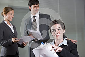 Three office workers meeting in boardroom