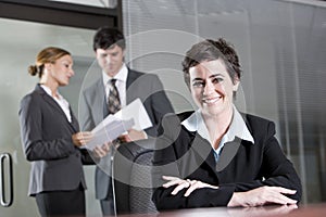 Three office workers meeting in boardroom