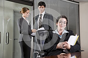 Three office workers meeting in boardroom