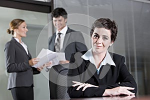 Three office workers meeting in boardroom