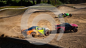 Three offroad RC cars turning into a sharp turn
