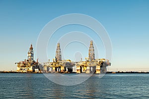 Three offshore oil rig platforms are in dry dock for maintenance