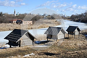 Three old barns on stilts near frozen Kamenka river - Suzdal Lan