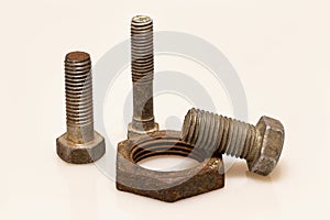 Three old bolts and a rusty nut