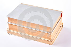 Three old books, white background.