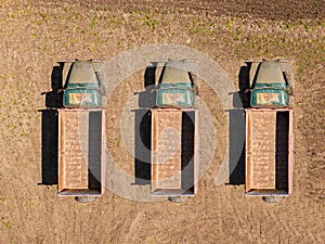 Three Old farm trucks.