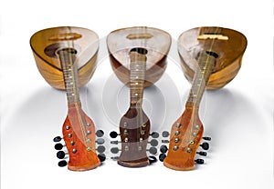 Three old mandolins rotated fingerboards to the camera. Isolated on a white background
