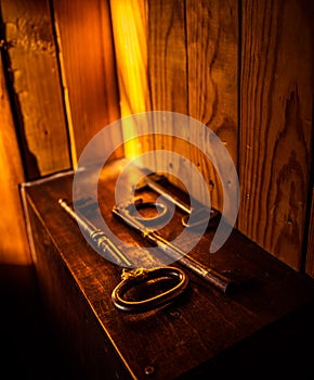 Three old metal kays on a wooden box. photo