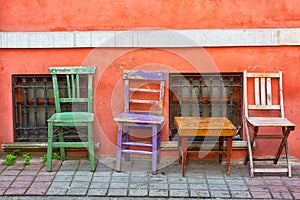 Three old multi-colored chairs