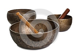 Three old Tibetian singing bowls on white