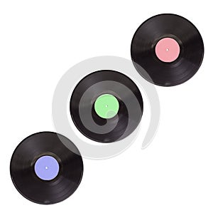 Three old vinyl records in different colors