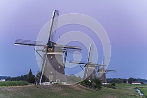 Three old windmills from the year 1672 in Stompwijk Molendriegang Stompwijk, the Netherlands just after sunset