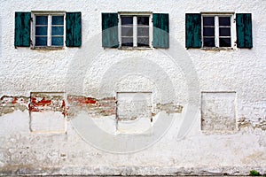 Three old windows on old white wall as background